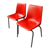 Pair of red plastic chairs with metal frame