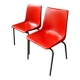 Pair of red plastic chairs with metal frame