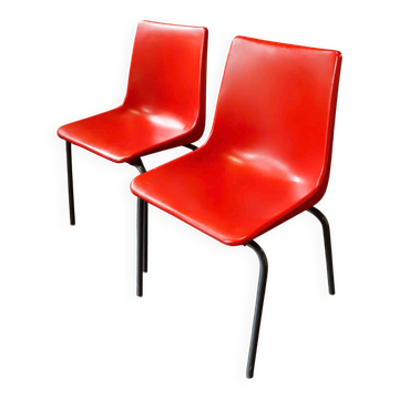 Pair of red plastic chairs with metal frame