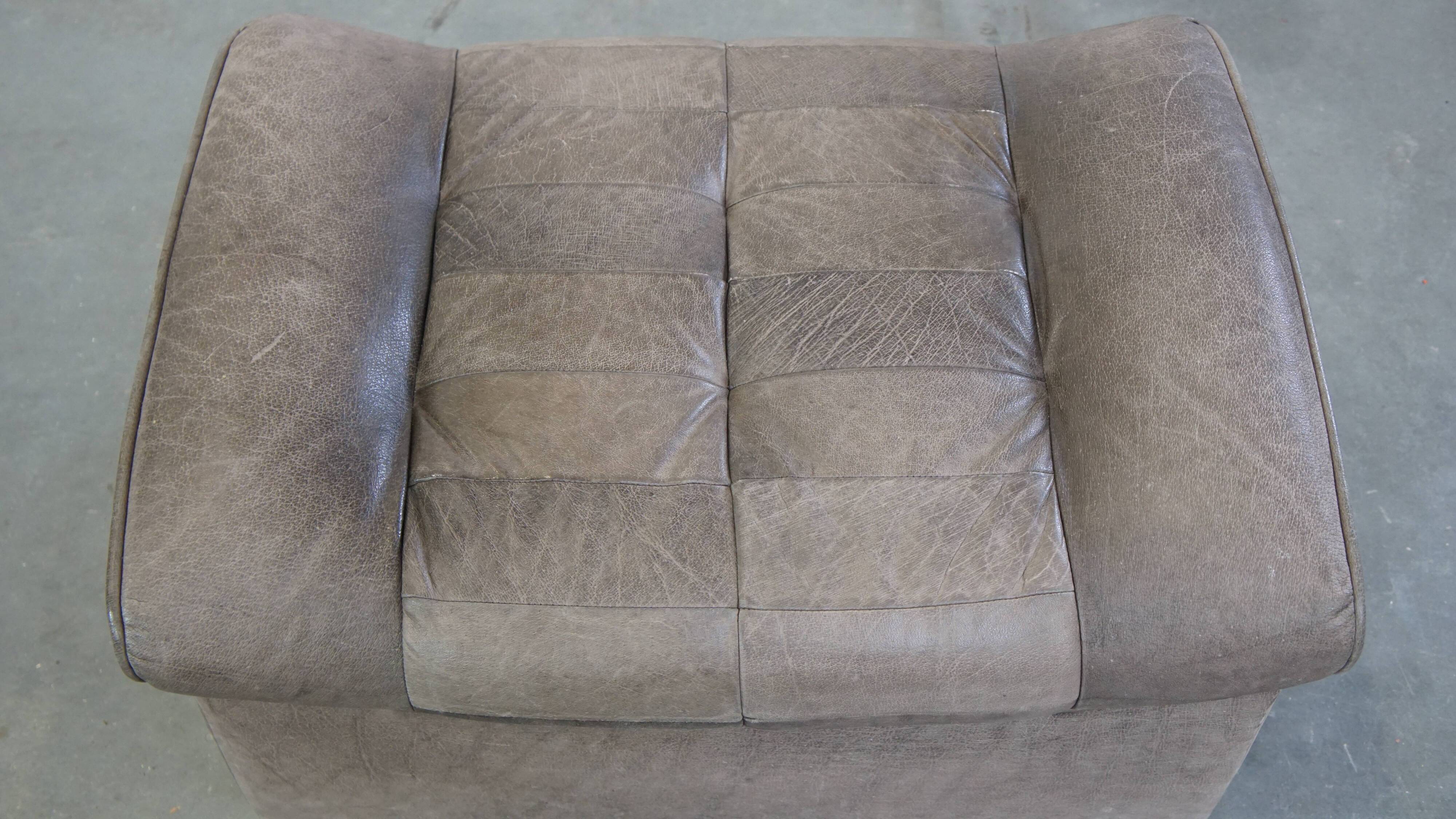 Luxurious, comfortable, gray leather vintage footstool