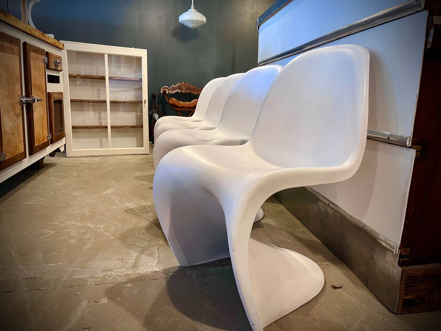 4 white Panton style armchairs