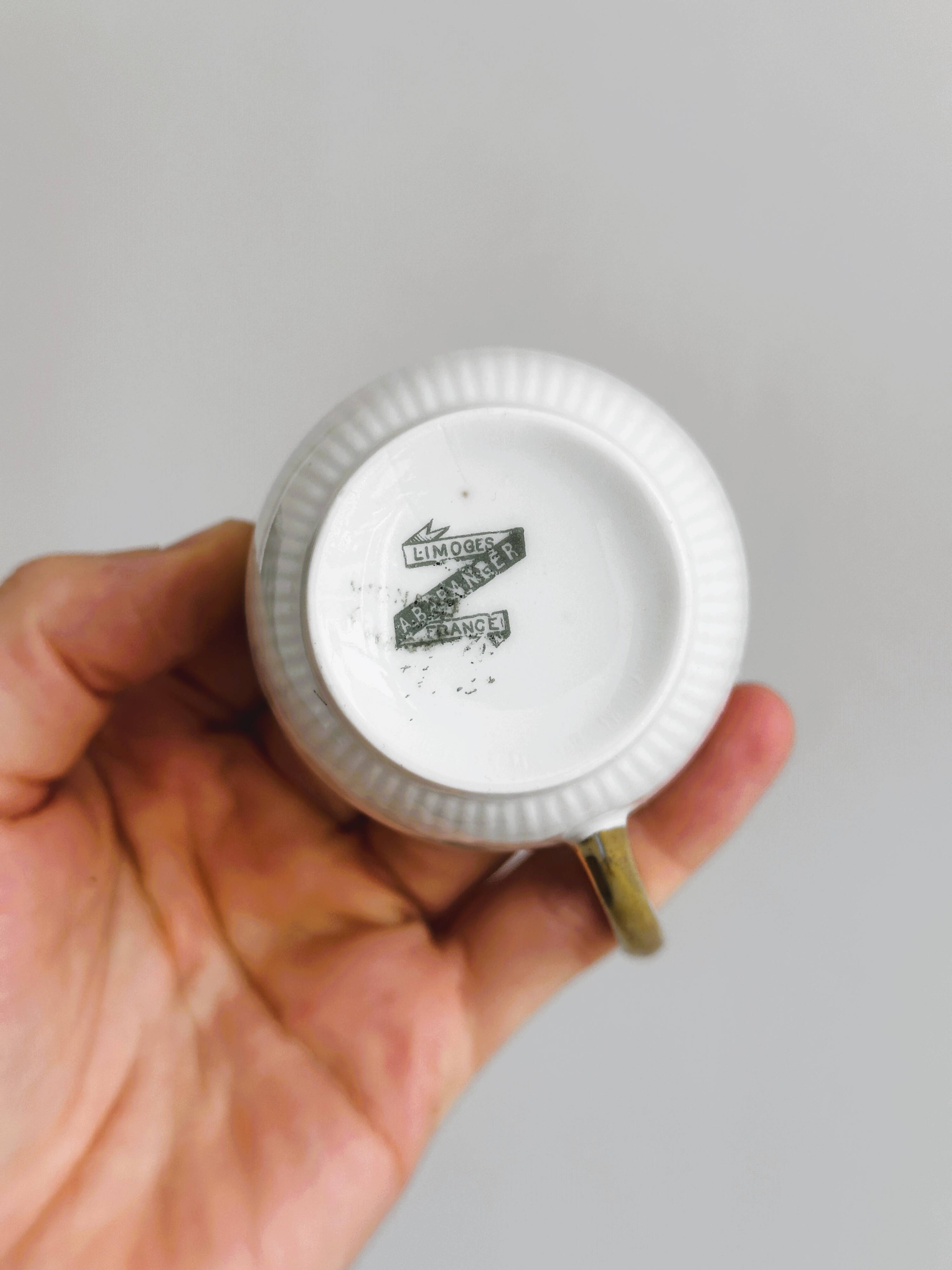 7 Limoges porcelain cups and saucers with gold decoration and floral motif.