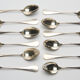 12 small silver metal spoons engraved "FB", early XXth