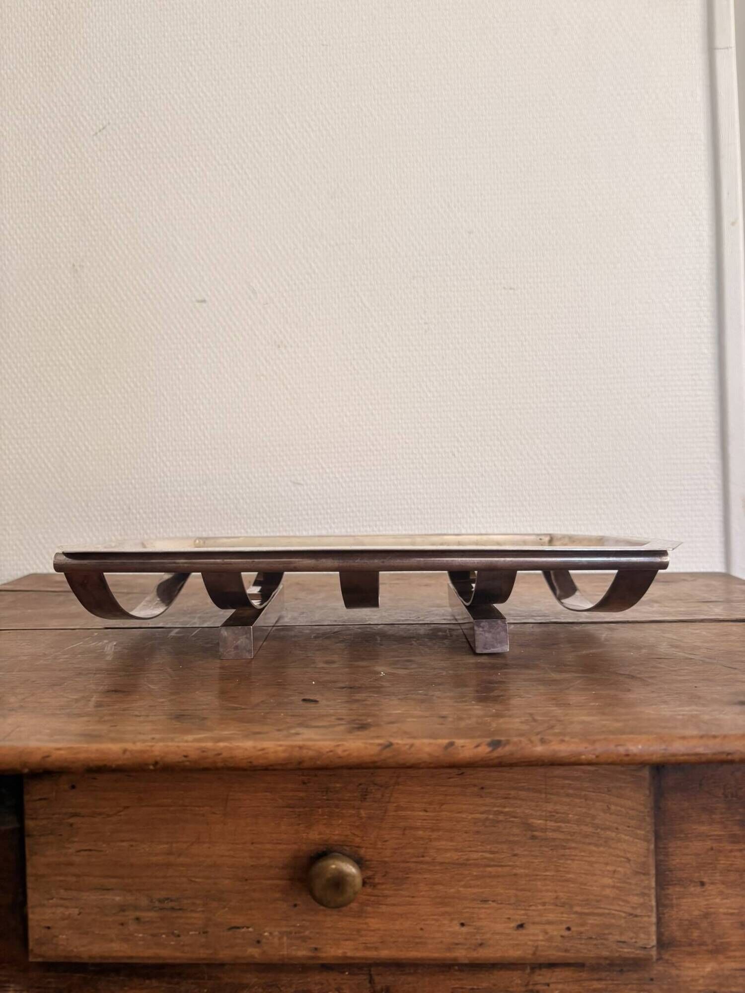 Art Deco metal plate, silvered, hammered on a flat vintage serving stand.
