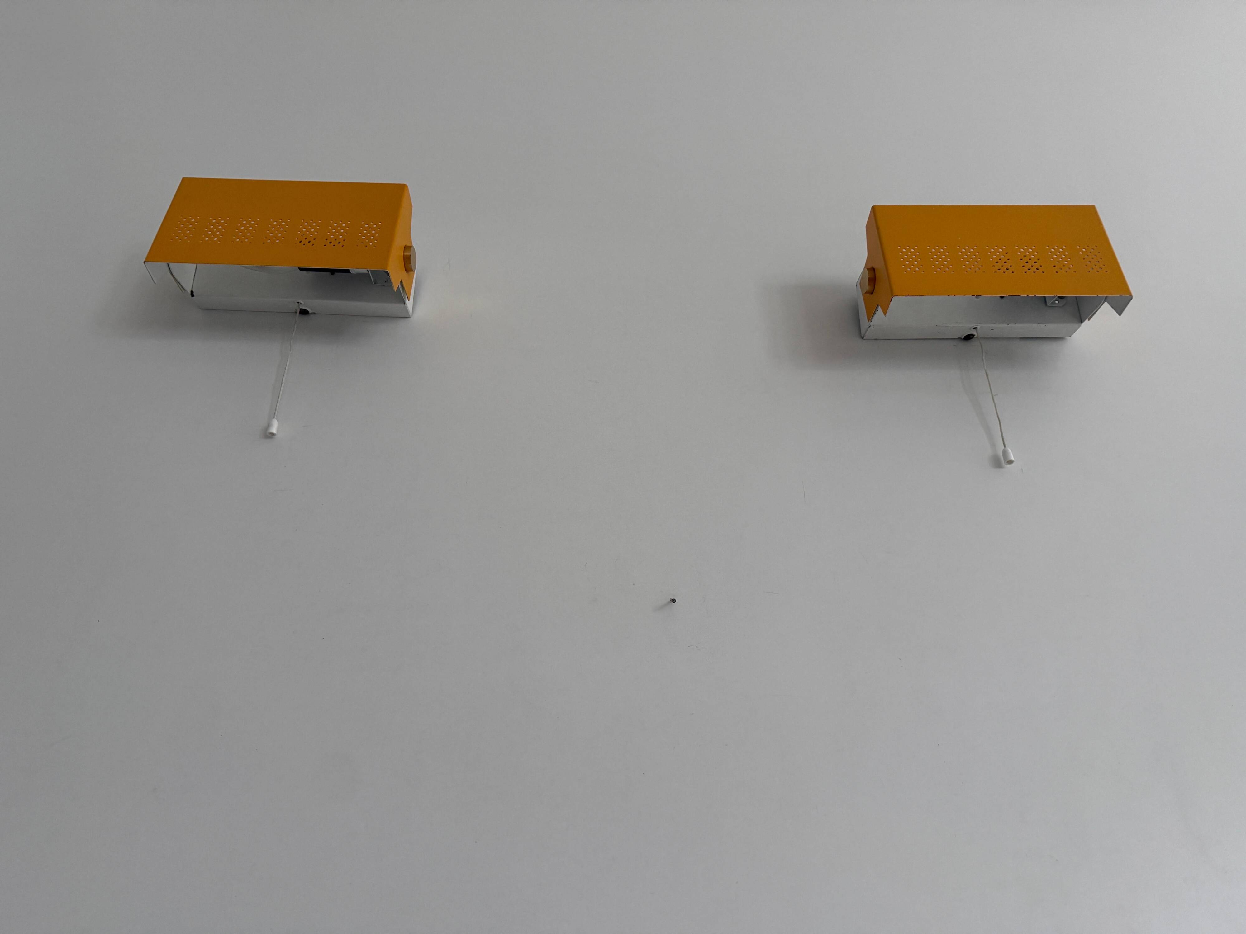 Pair of yellow metal wall lights from the mid-century by N Leuchten, 1960s, Germany.