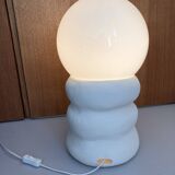 Large table lamp in off-white ceramic with an organic globe shape.