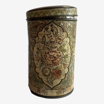 Round metal box with floral pattern