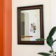 Old wall mirror 72 x 52 cm in black wood and faux mahogany