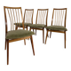 Scandinavian chairs with green velvet upholstery.