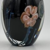 Double-lined blown glass vase with flower inclusions.