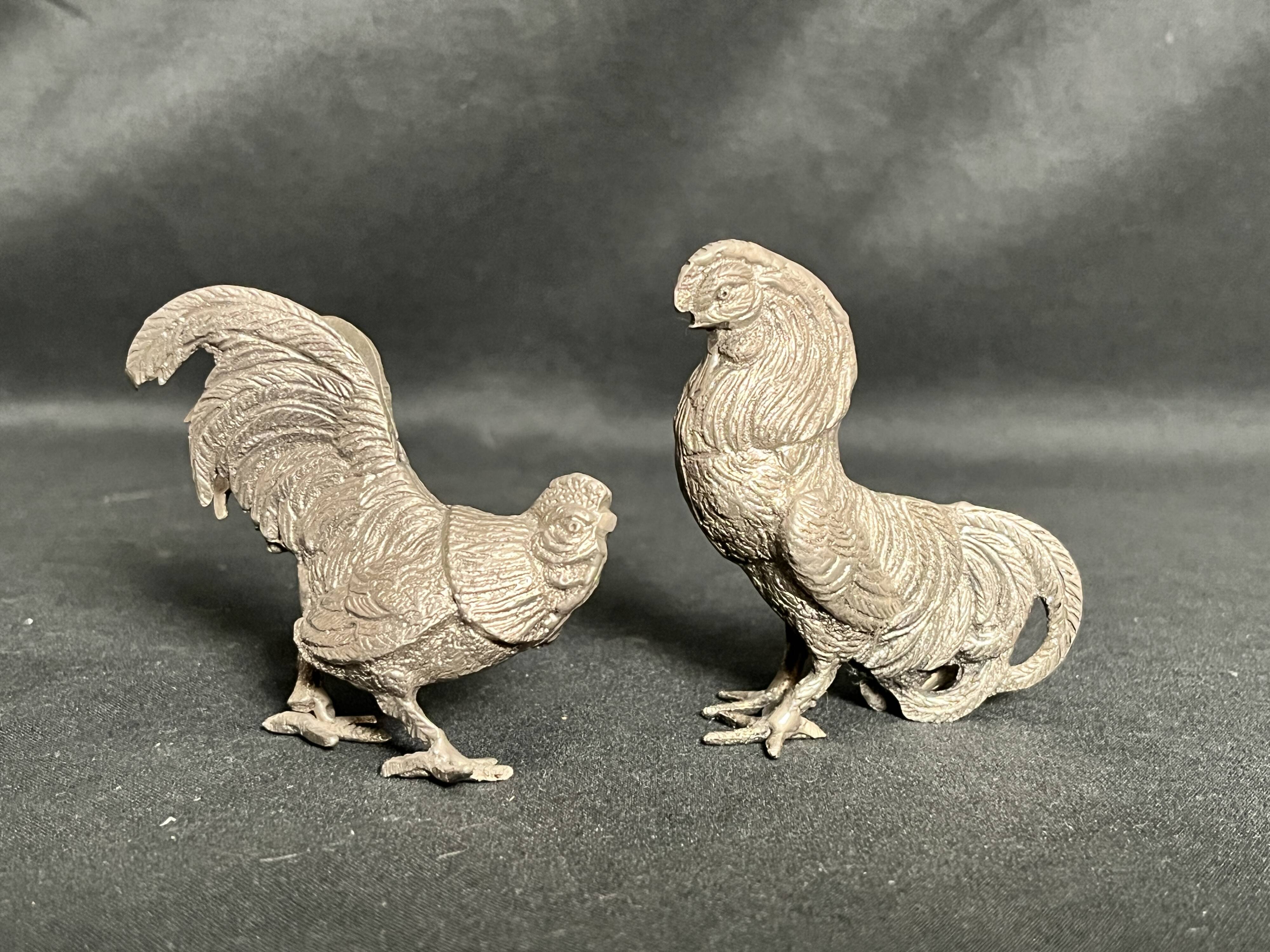 Showcase objects, two 20th century metal rooster and hen subjects