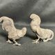 Showcase objects, two 20th century metal rooster and hen subjects
