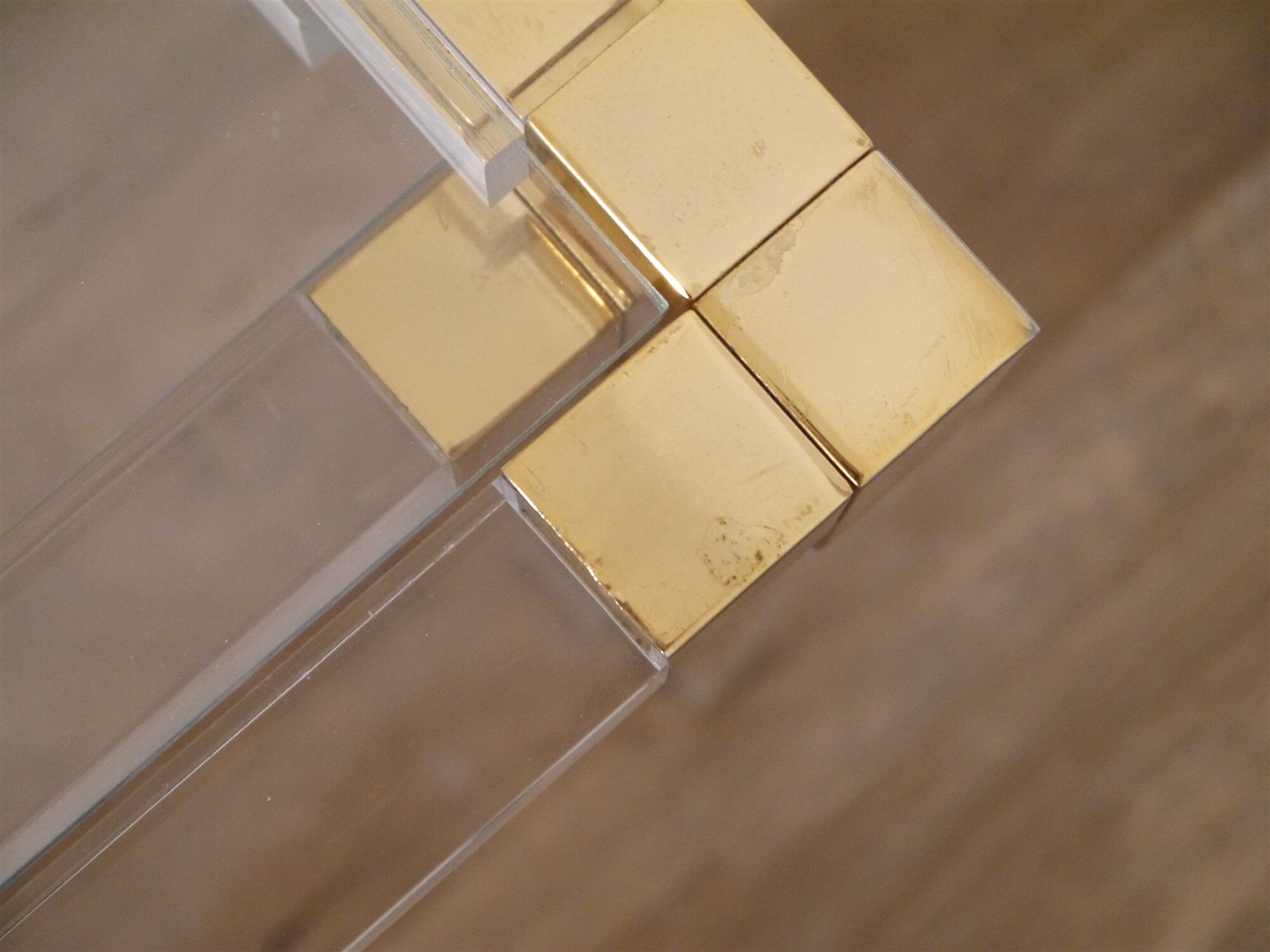 Nesting tables from the 1970s in brass, glass and lucite