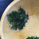 Plate signed with green leaf decoration.