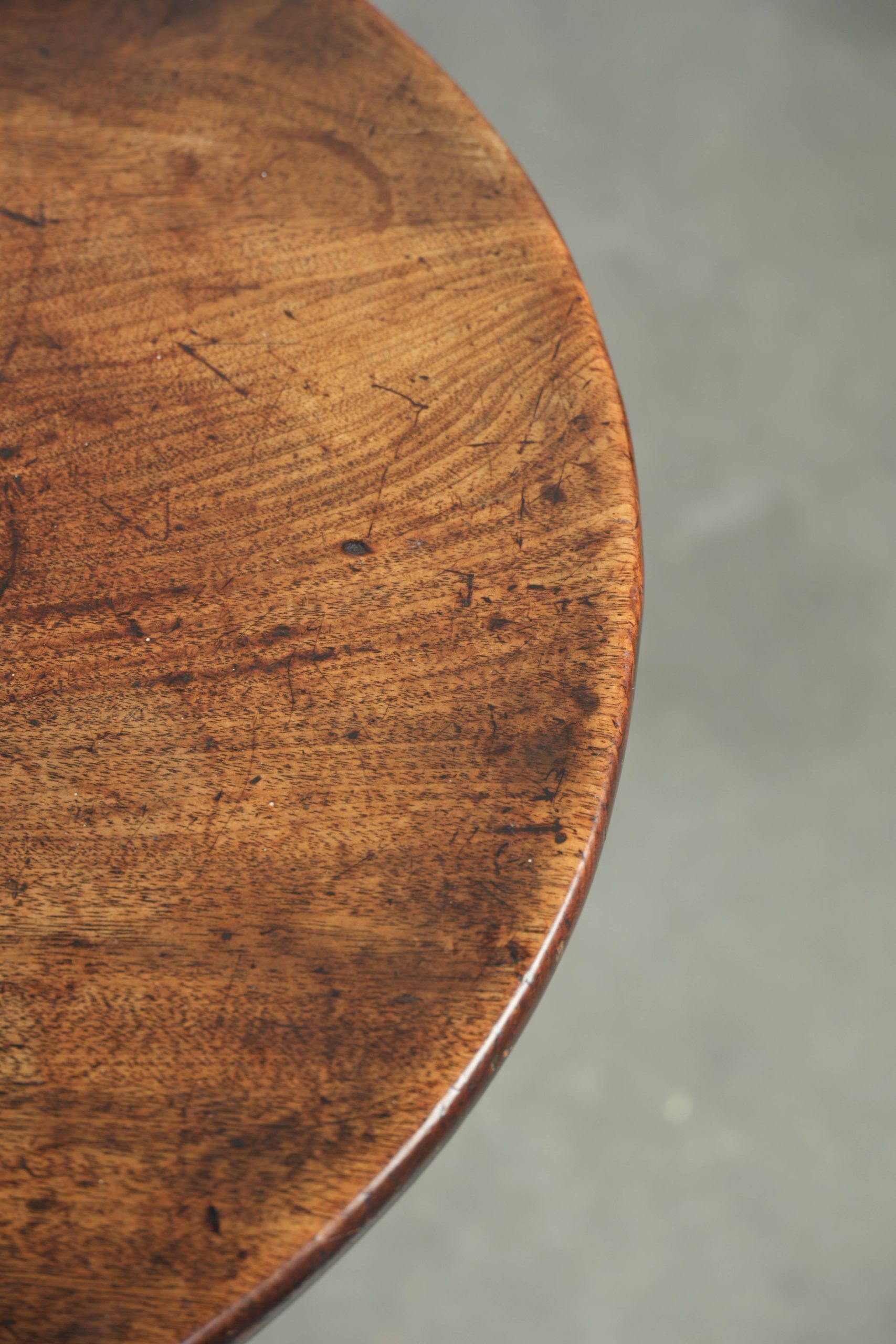 Round antique side/wine table from the late 18th century with a subtle foot