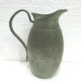 Art deco pitcher in hammered tin and signed E.H. Derbesy