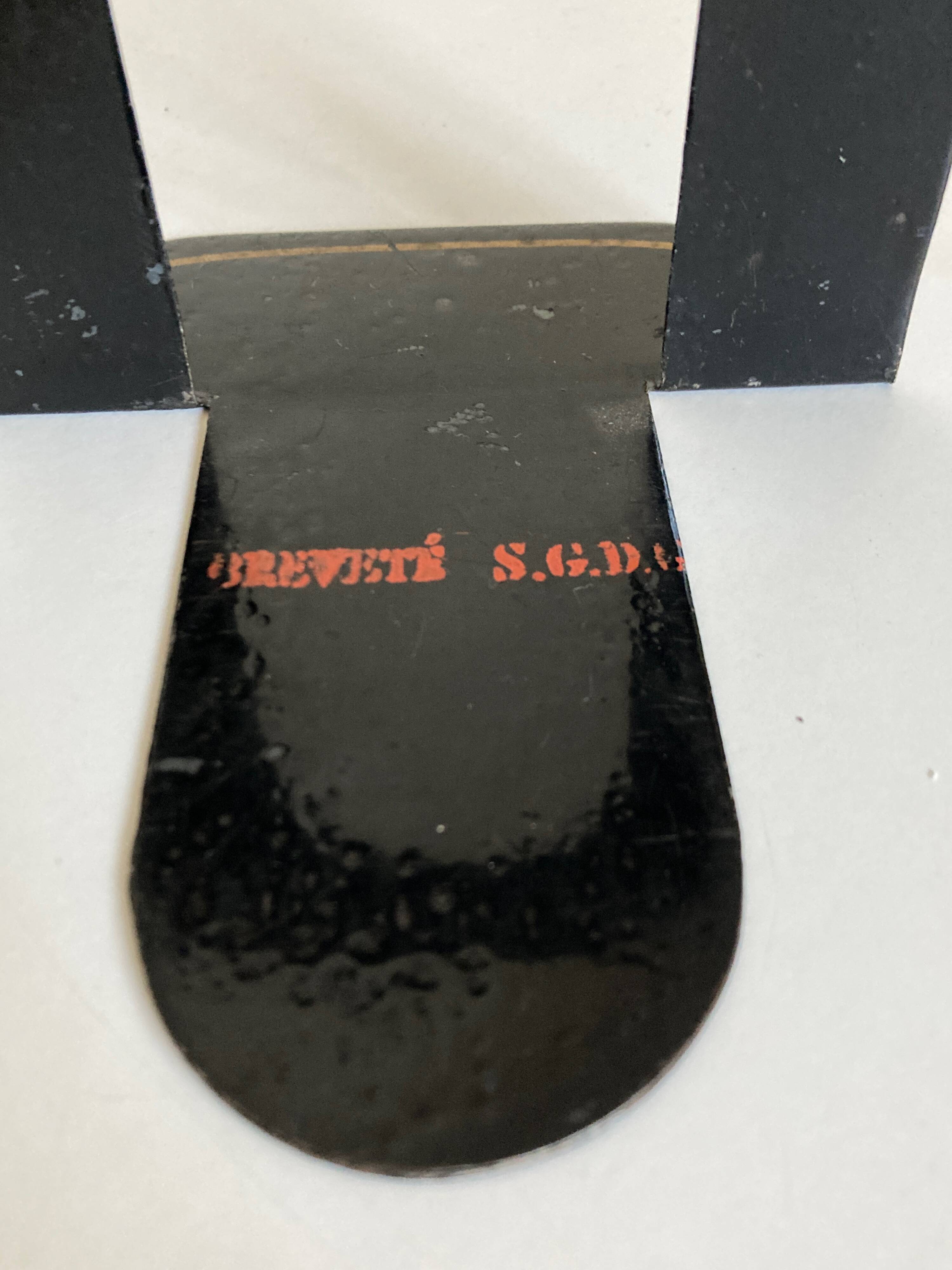 Pair of heavy metal bookends, folded, 1920.