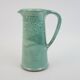 Large green ceramic pitcher with leopard enamel