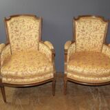 Pair of Louis XVI Bergères in walnut, late 18th century.