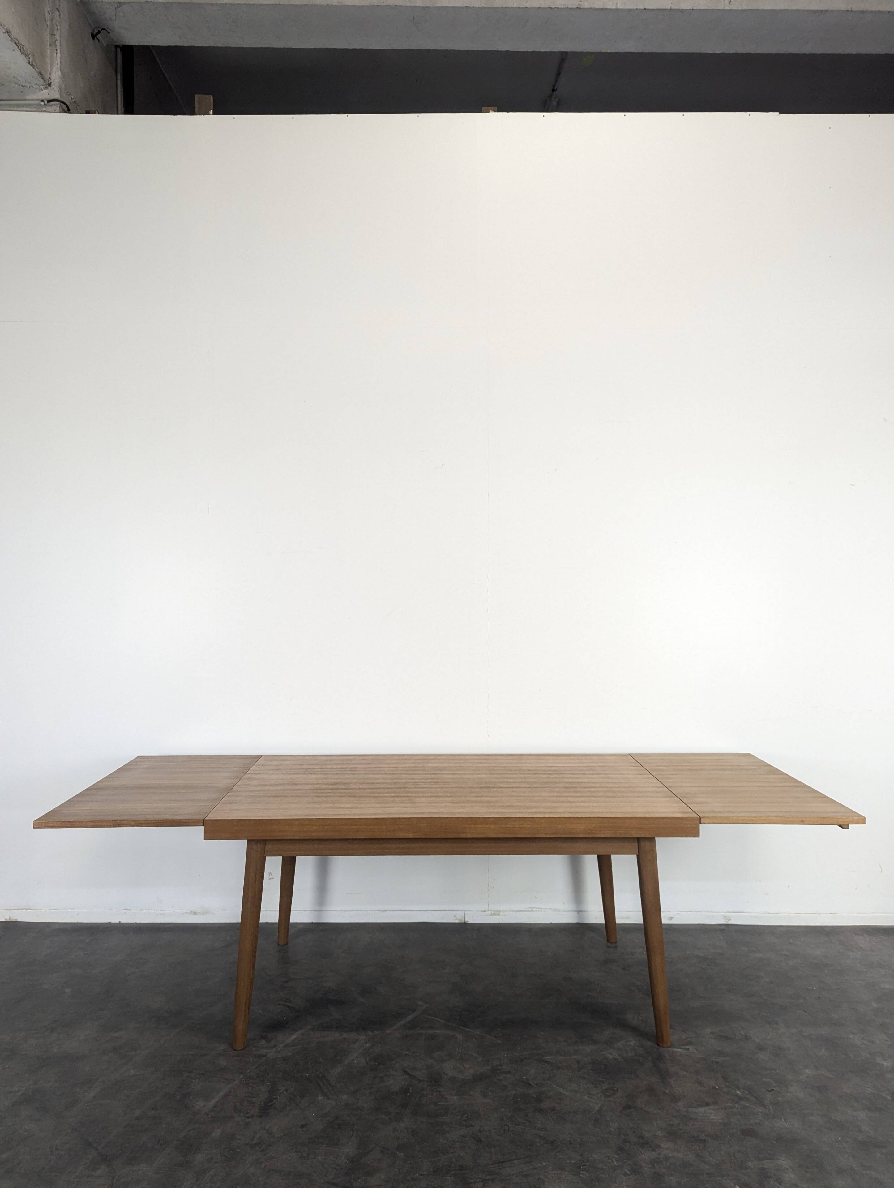 Modernist teak table with 2 extensions.