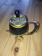 Original vintage ashtray on a small wheeled stand.