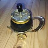 Original vintage ashtray on a small wheeled stand.