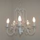 Chandelier vintage en métal blanc à 5 lumières avec des fleurs de glycine roses.