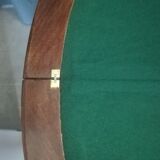 Half-moon mahogany game table on casters