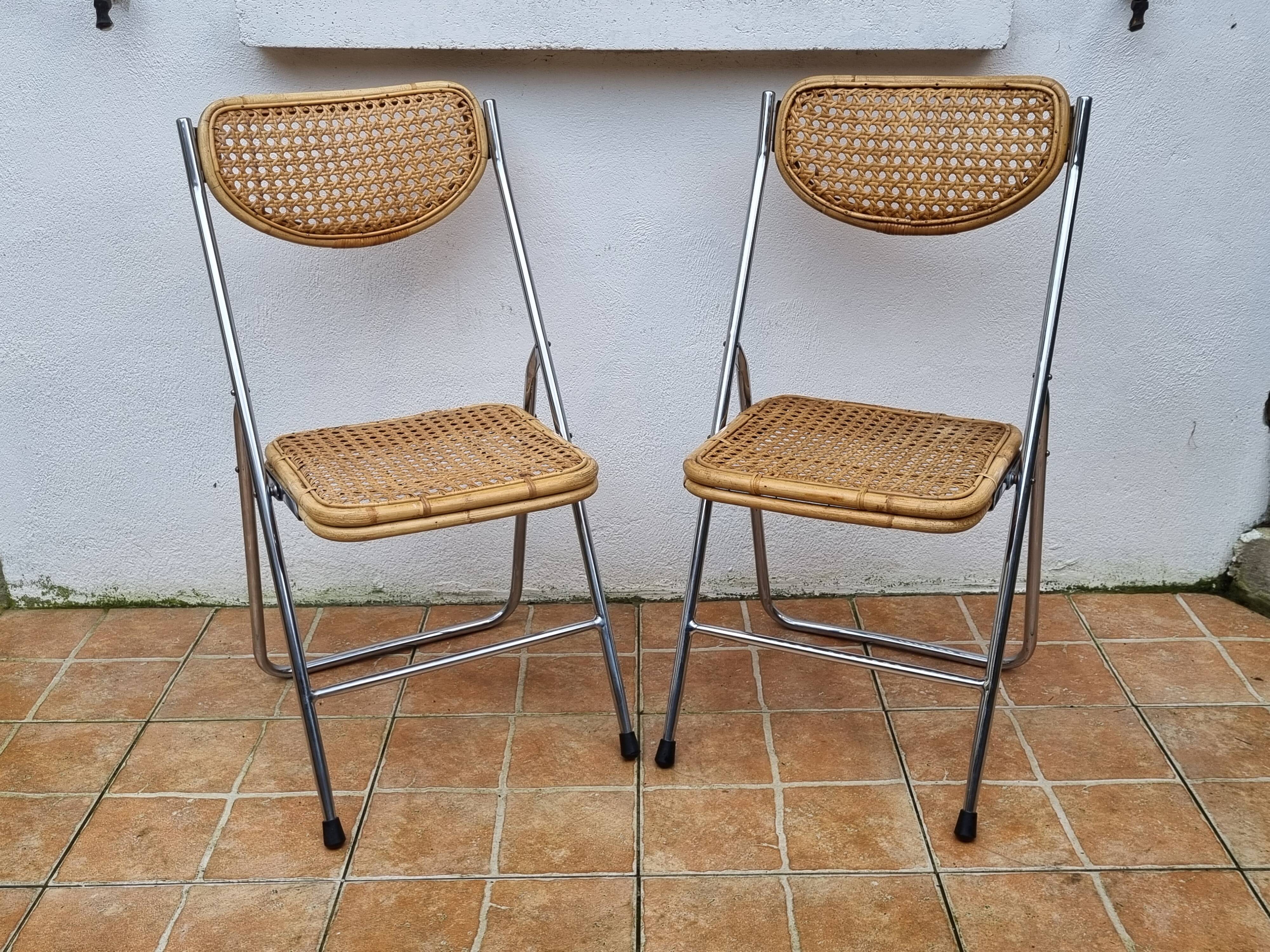 Pair of vintage metal and cane folding chairs