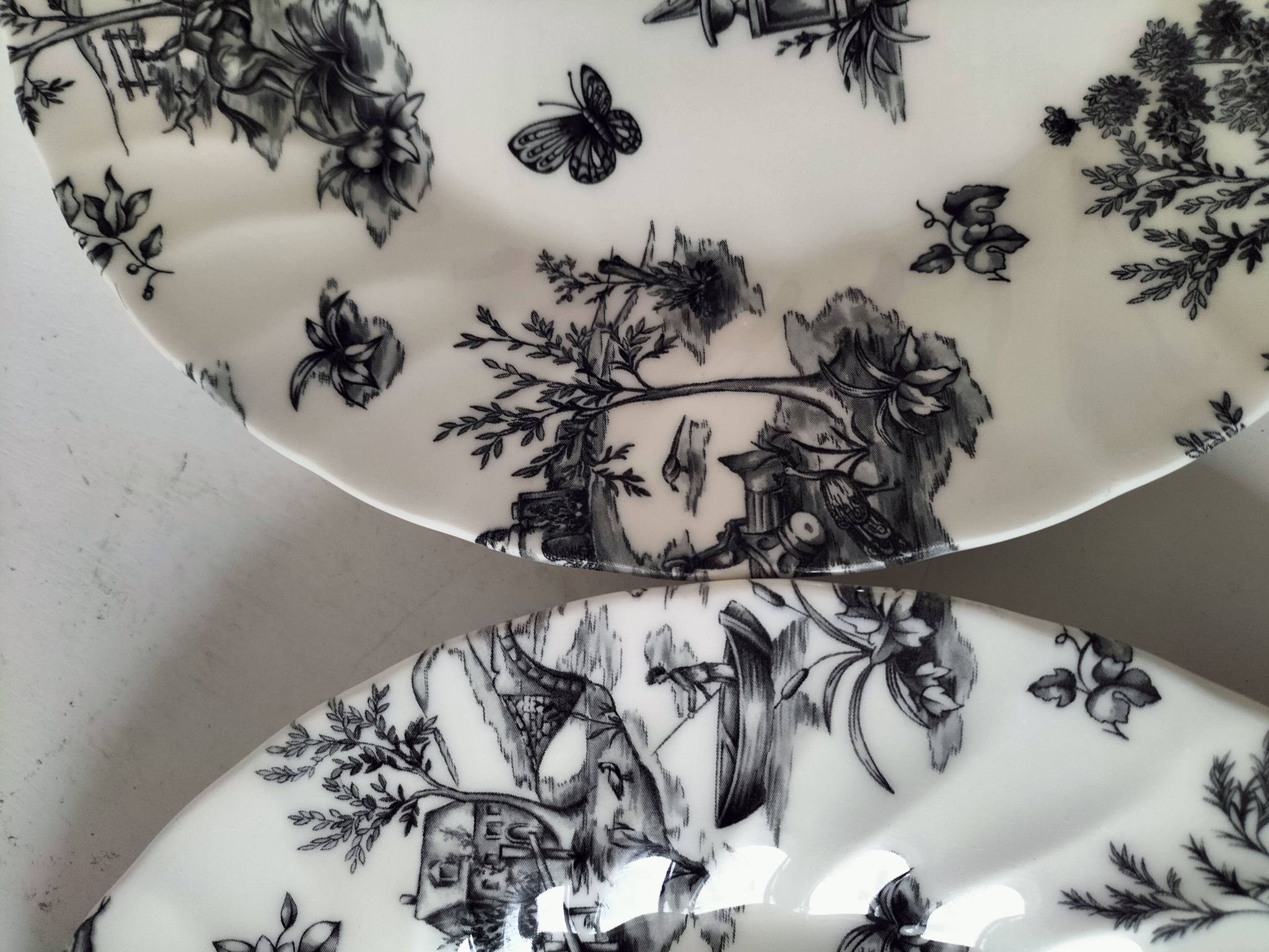 Set of black and white plates in the style of toile de Jouy.