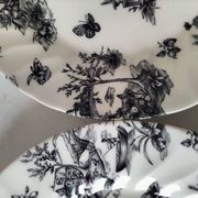 Set of black and white plates in the style of toile de Jouy.