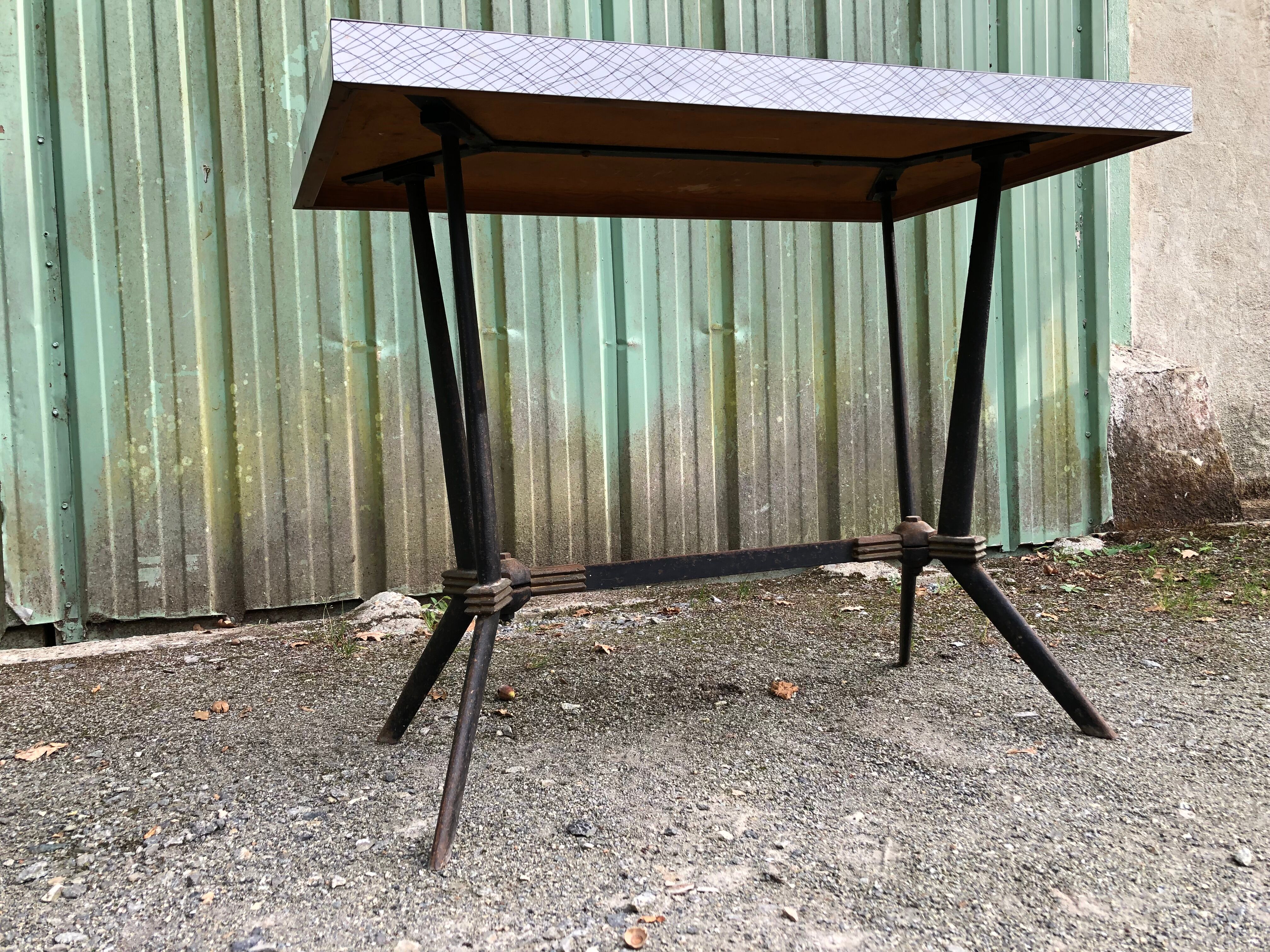 Vintage bistro table with an Art Deco style cast iron base and Formica top.