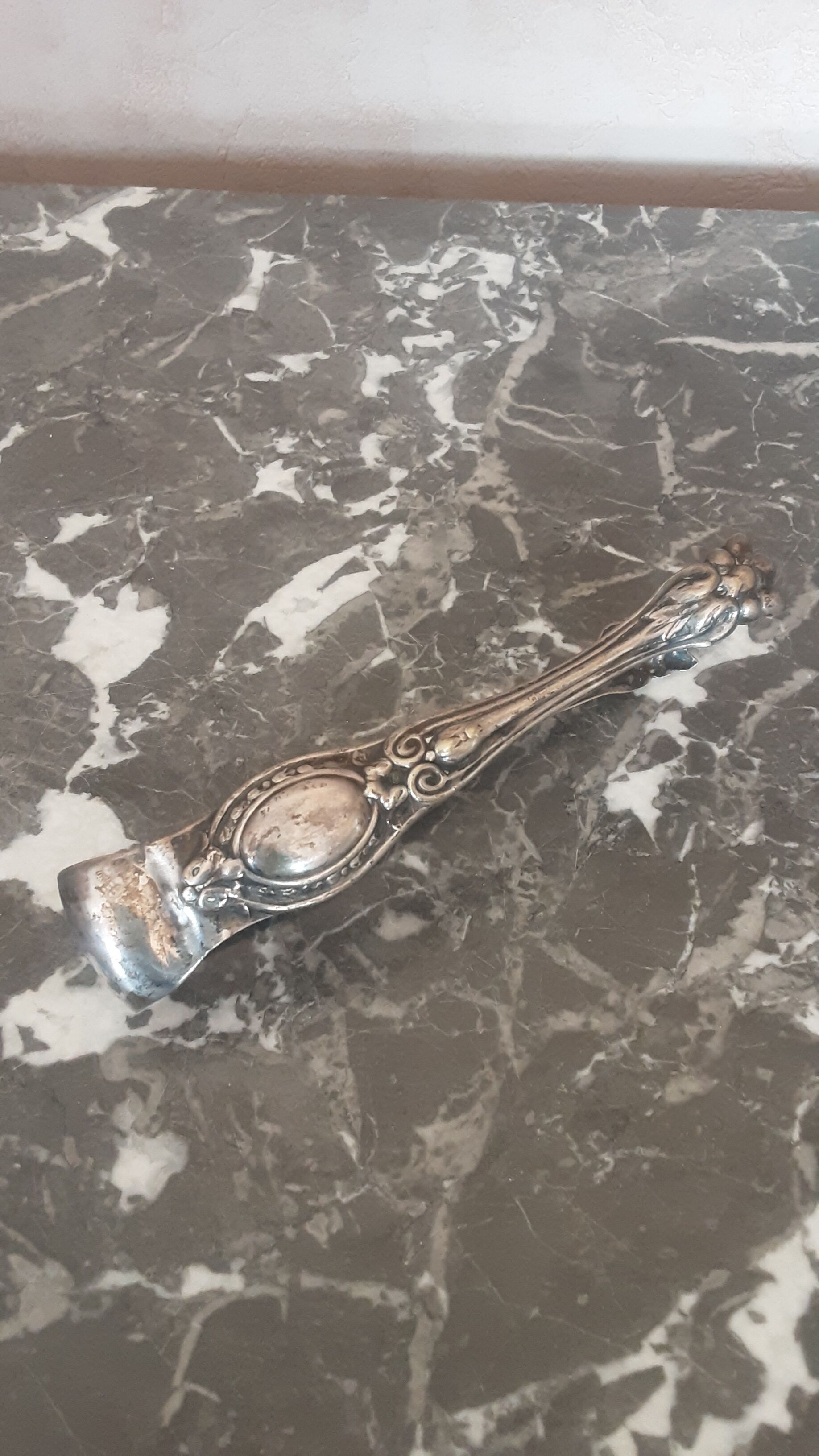 Antique silver metal sugar clamp