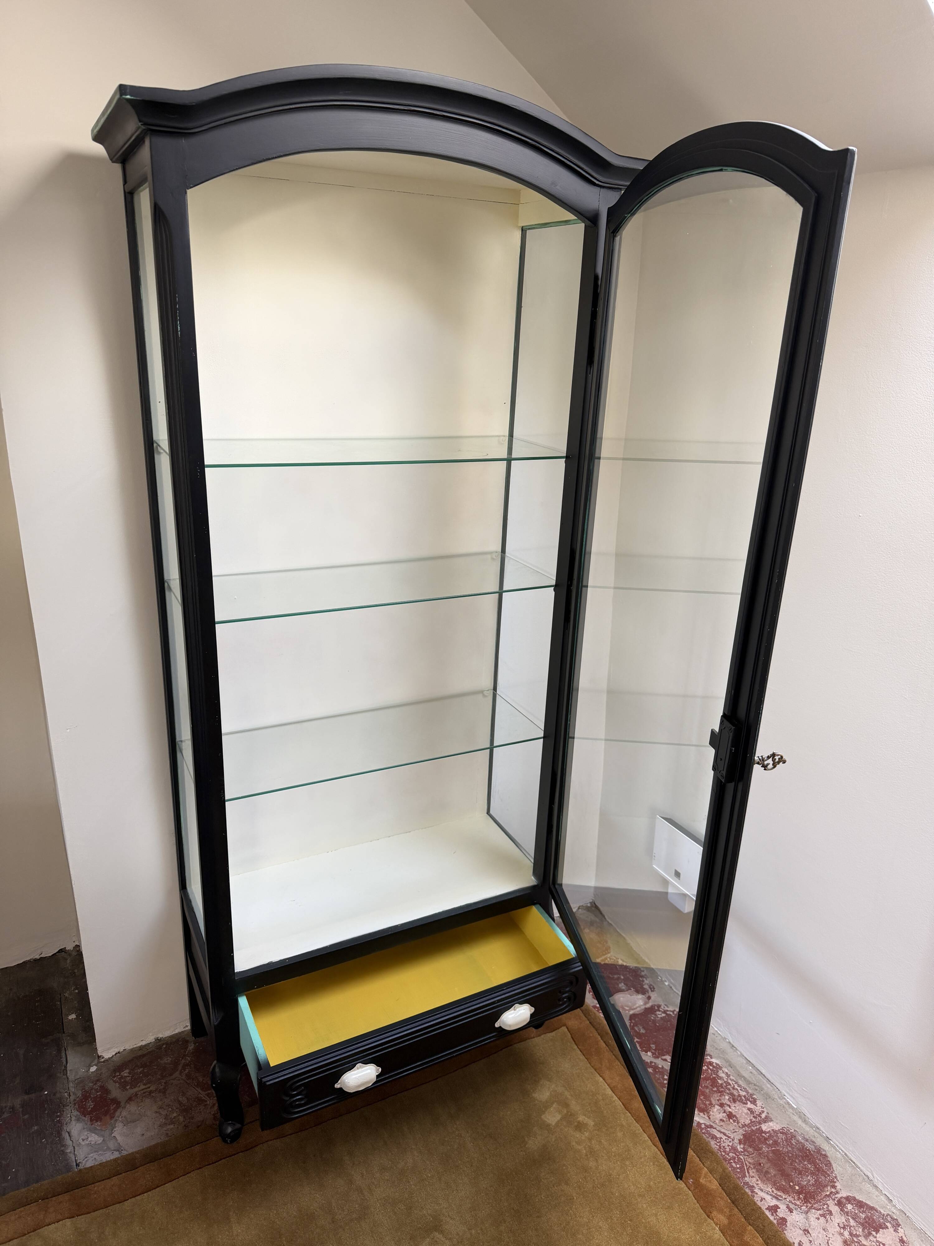 Antique display cabinet repainted in black.