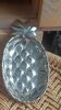 Silver-plated metal tray in the shape of a pineapple.