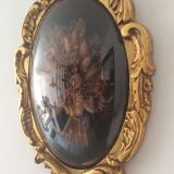 Golden wood frame and vintage bulging glass