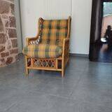 Vintage armchair in bamboo and rattan with a tartan pattern.