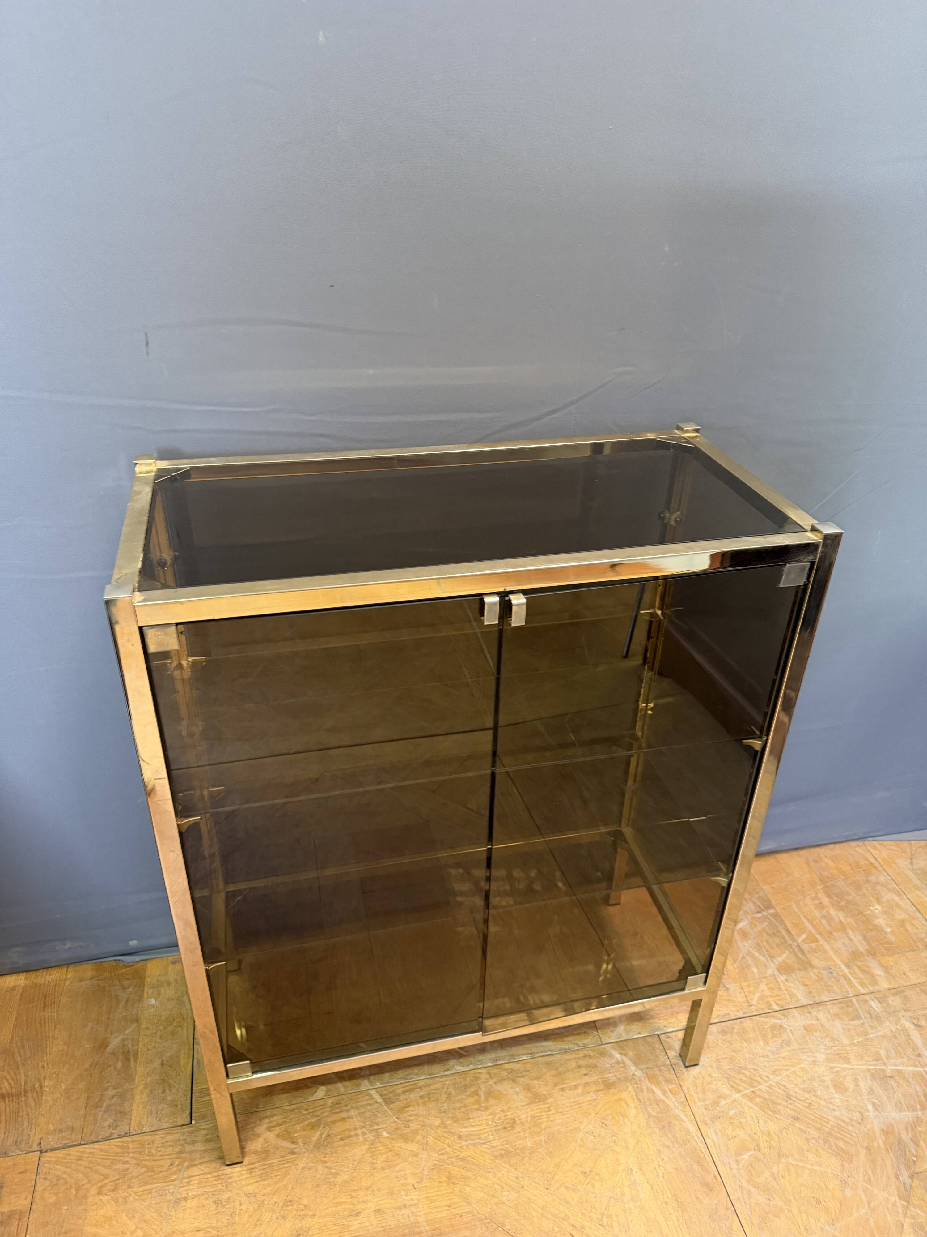 Chrome-plated brass display cabinet with smoked glass.
