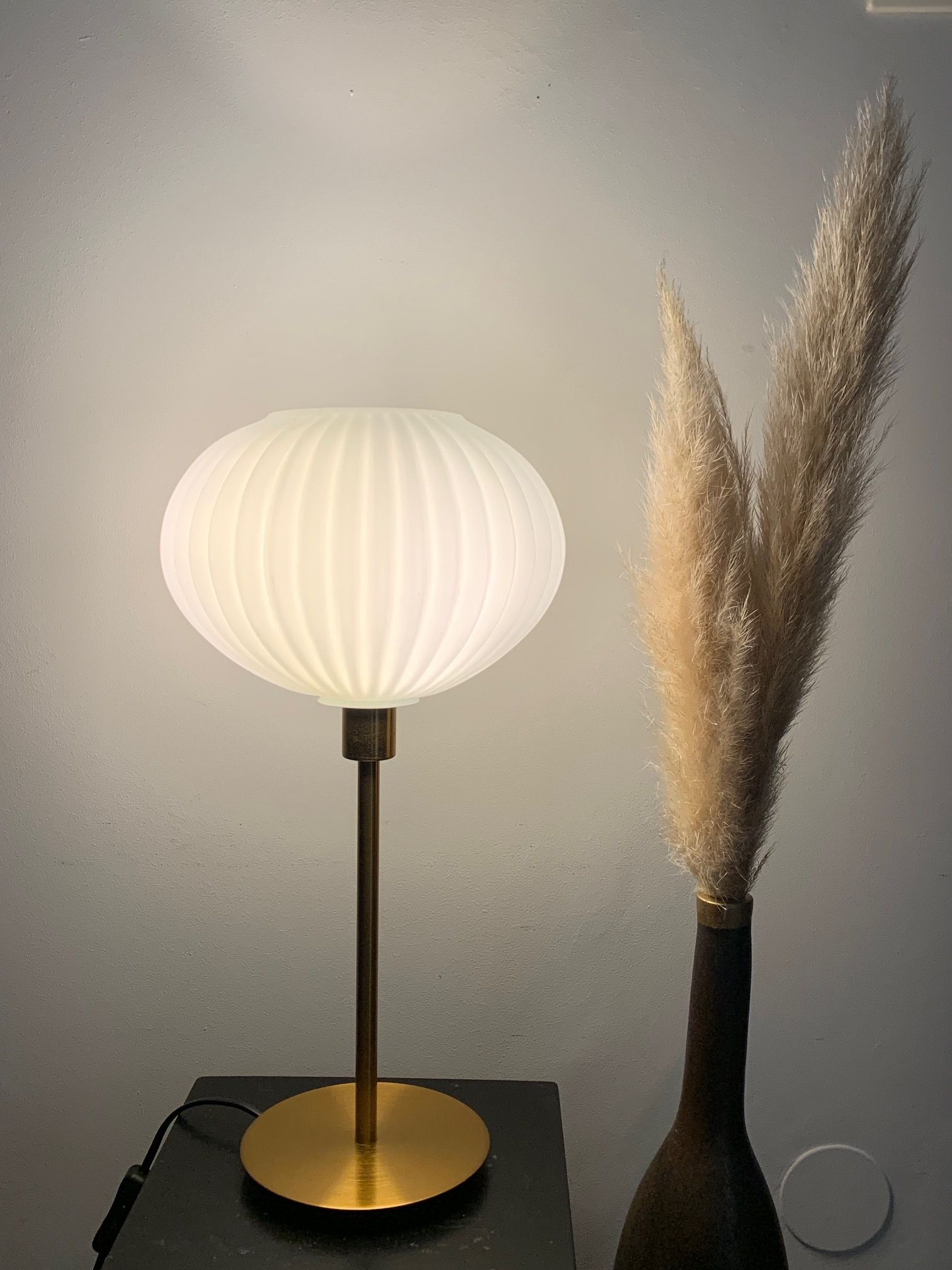 Table lamp with an antique white opaline lampshade and a vintage golden foot