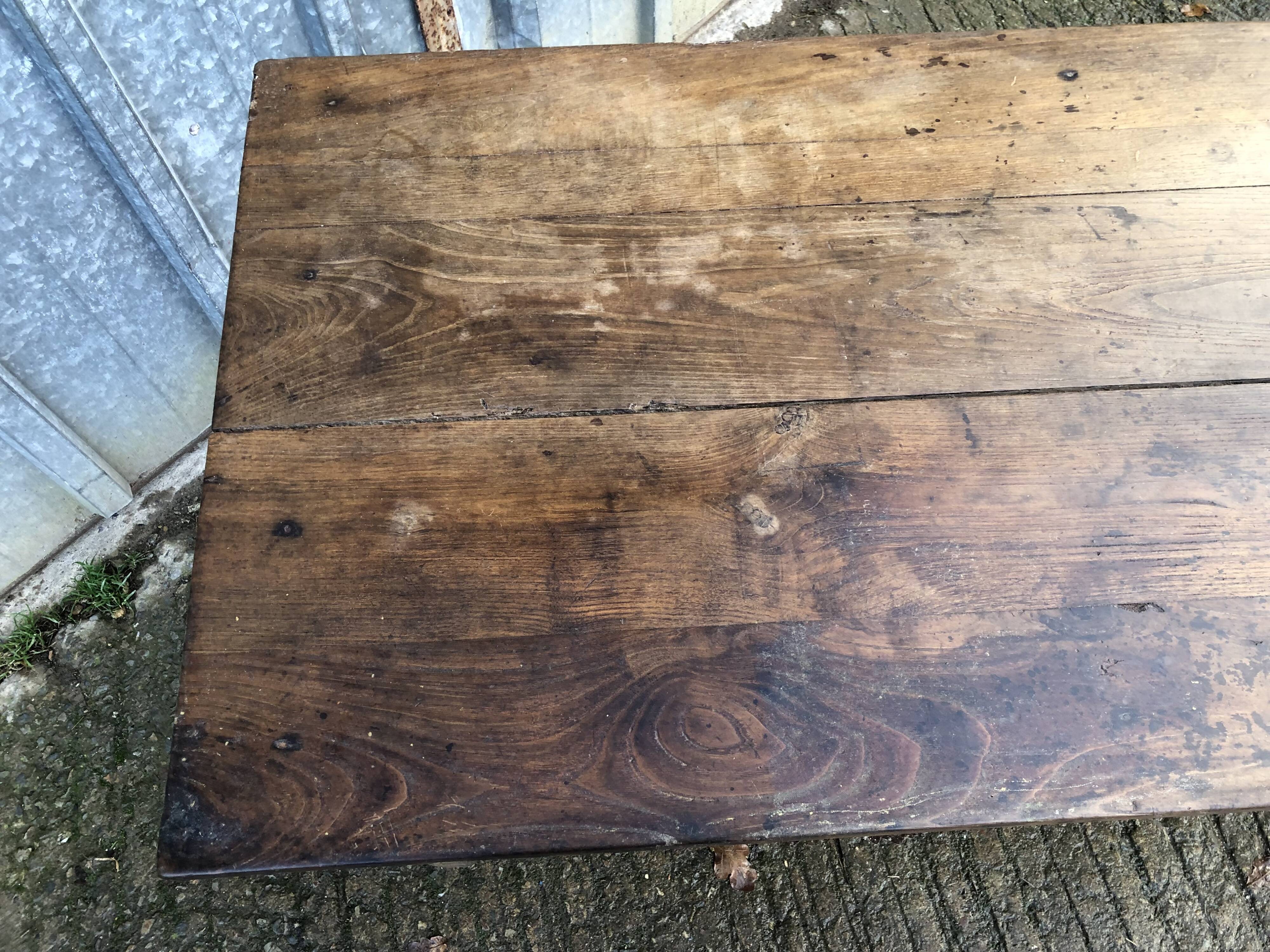 Old chestnut table with 3 front drawers and a cat bar.