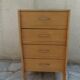 Vintage chest of drawers in raw wood.