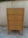 Vintage chest of drawers in raw wood.