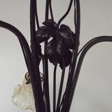 French Art Nouveau leaf detail iron three-light chandelier with amber glass shades.