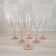 6 champagne flutes with pink stems