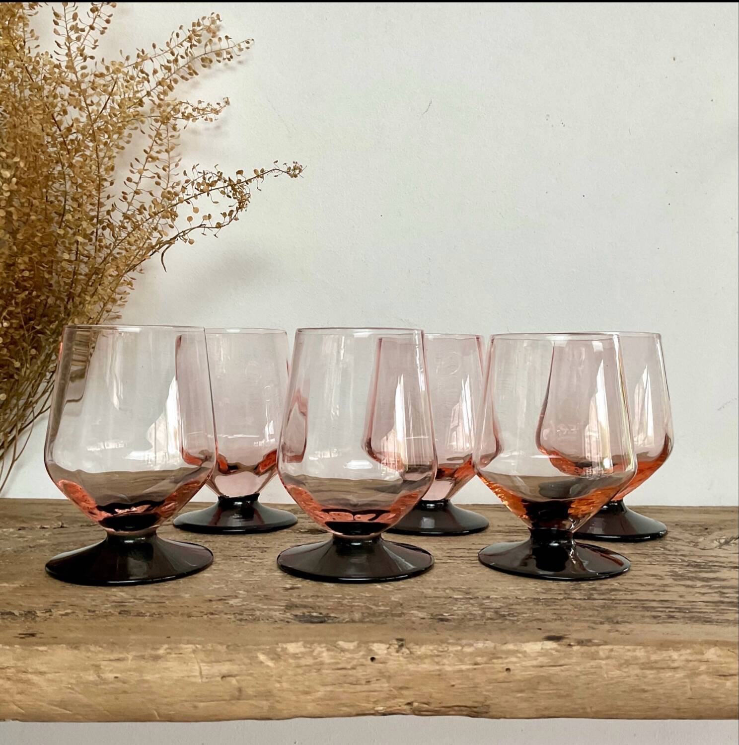 6 small pink glasses with black stems