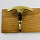 Vintage wall coat rack in brass and wood design.