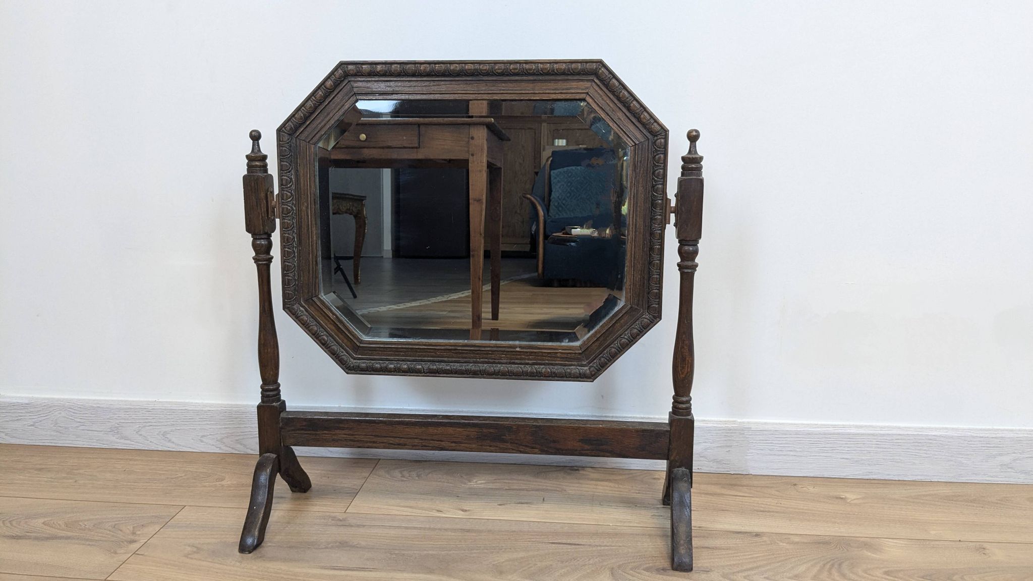 Antique beveled octagonal vanity mirror in carved wood
