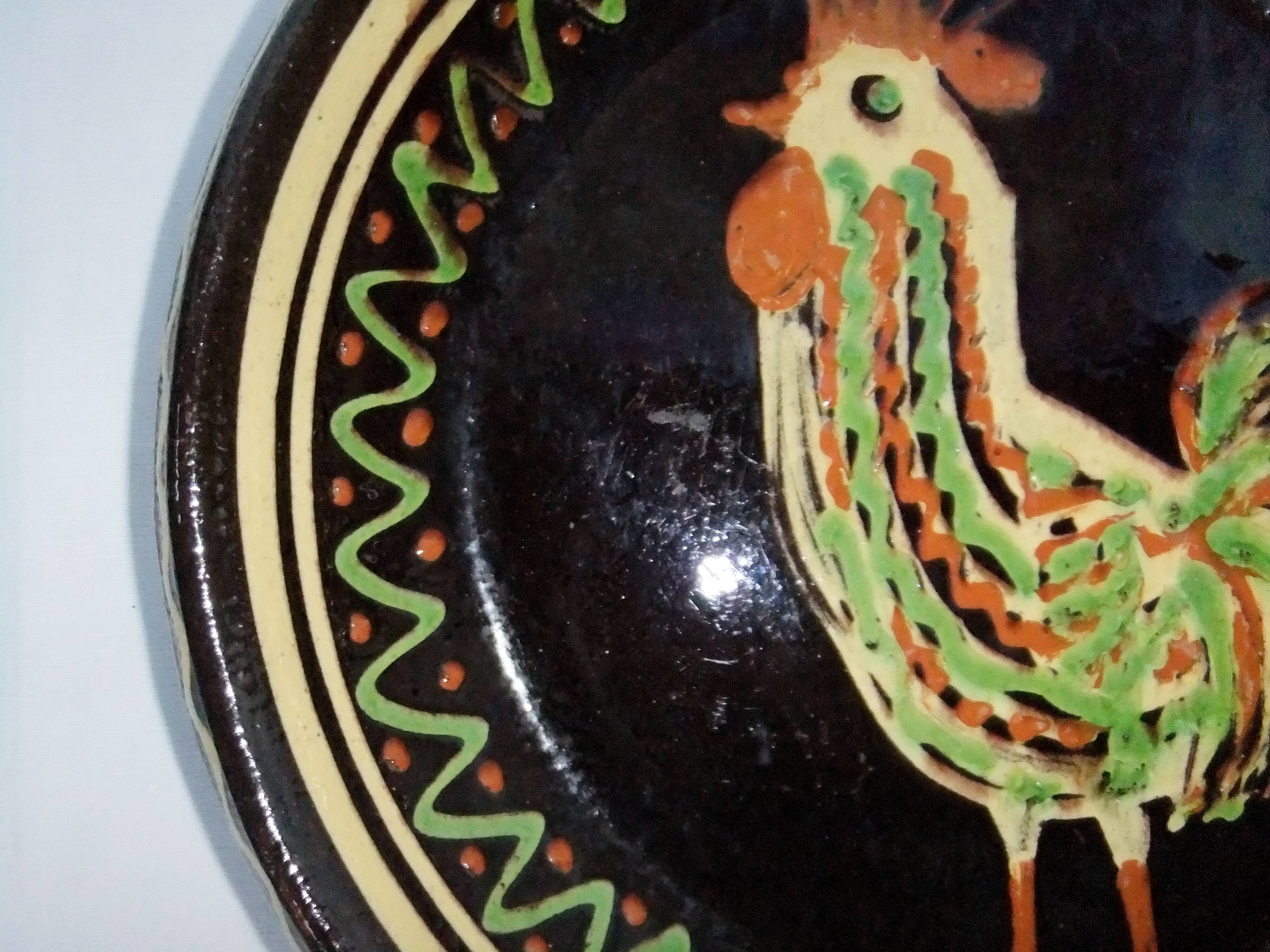 old terracotta dish decorated with rooster