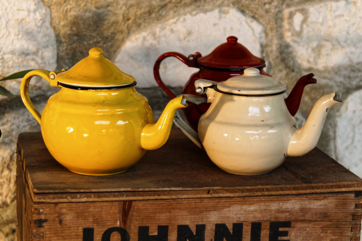Trio of small enamelled teapots