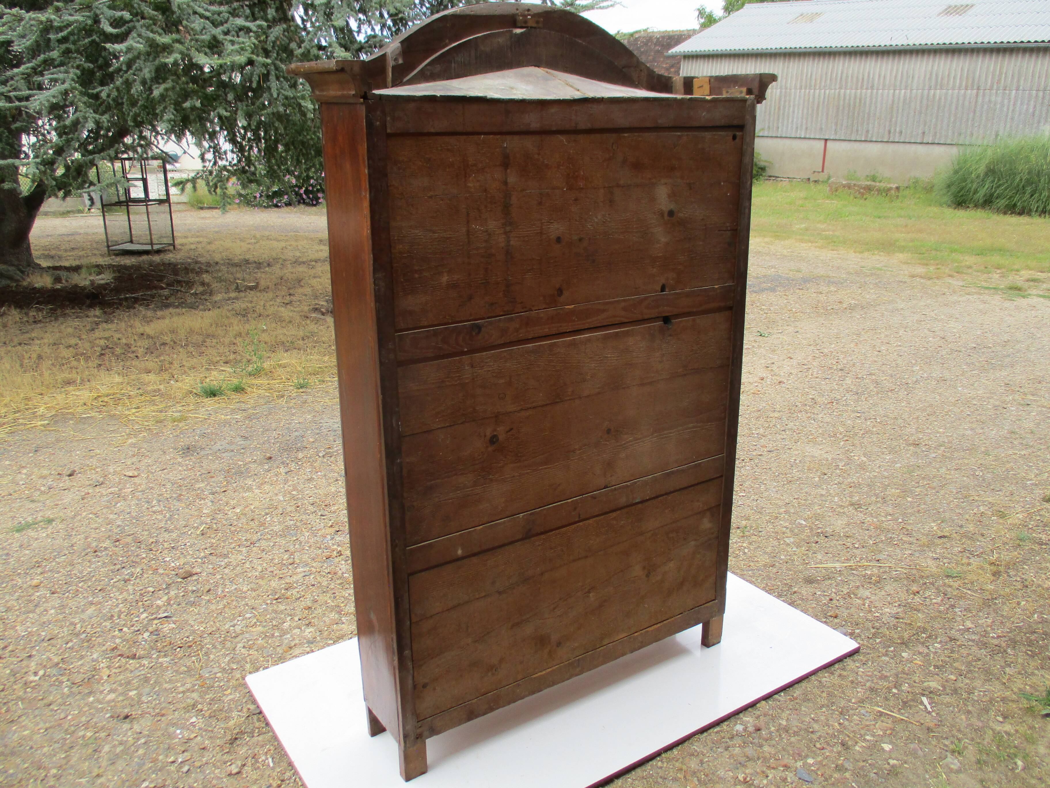 Small solid wooden cabinet with a gendarme hat